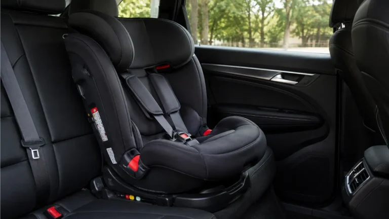 Child car seat fitted in the back seat of a taxi